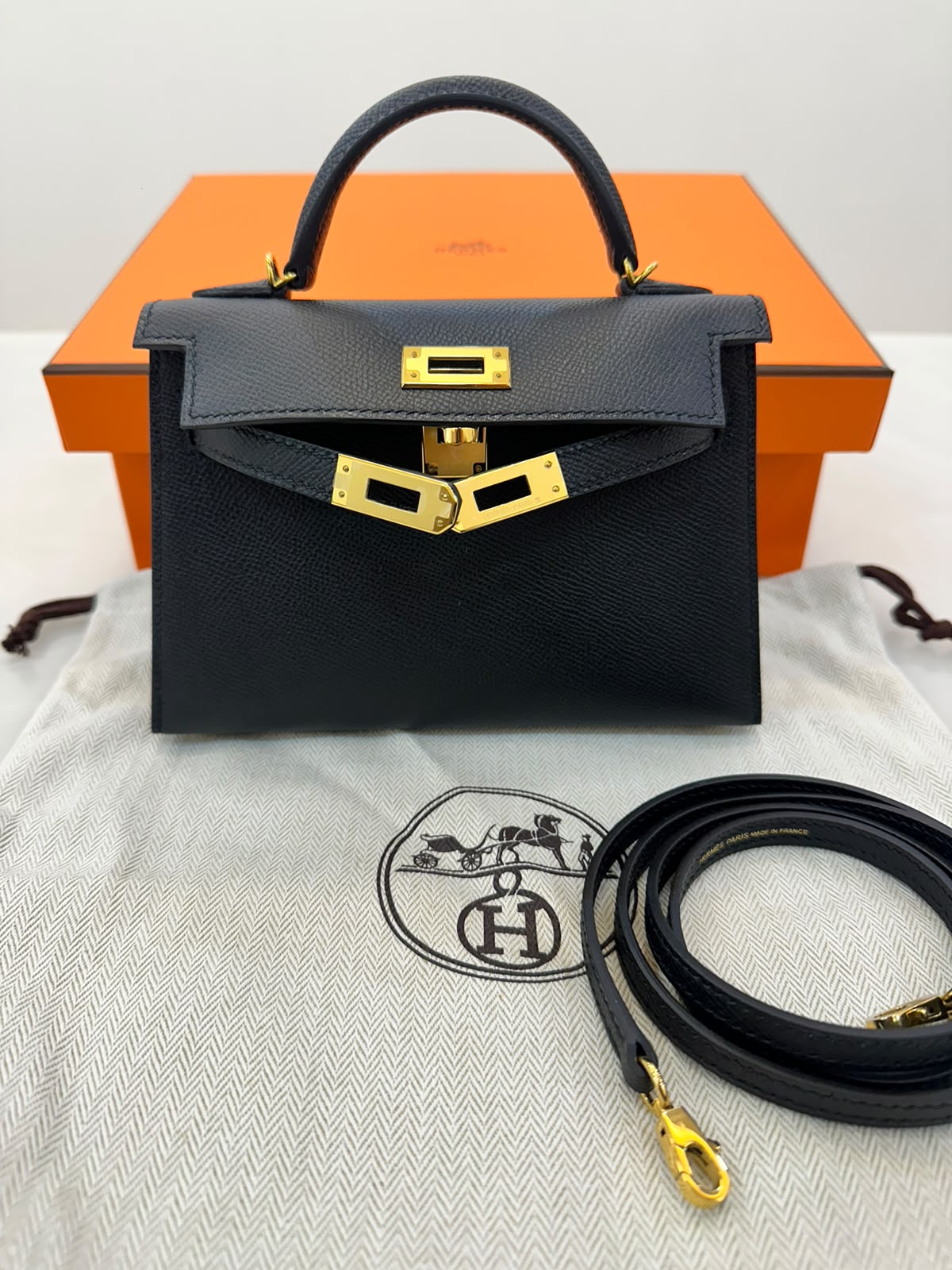 Hermès Mini Kelly in black Epsom leather with gold hardware.