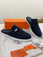 Hermès Likely mules featuring dark blue suede leather