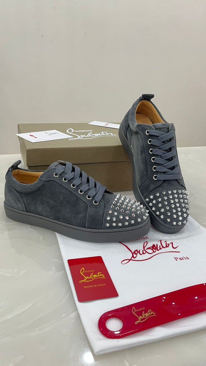 Christian Louboutin Louis Junior Spikes sneakers feature a grey suede