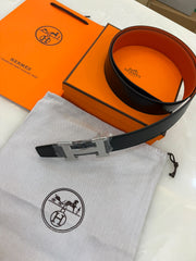 Reversible leather "H" buckle and a black and orange strap