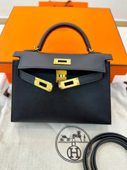 Hermès Mini Kelly in black Epsom leather with gold hardware.