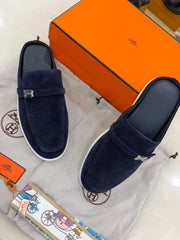 Hermès Likely mules featuring dark blue suede leather